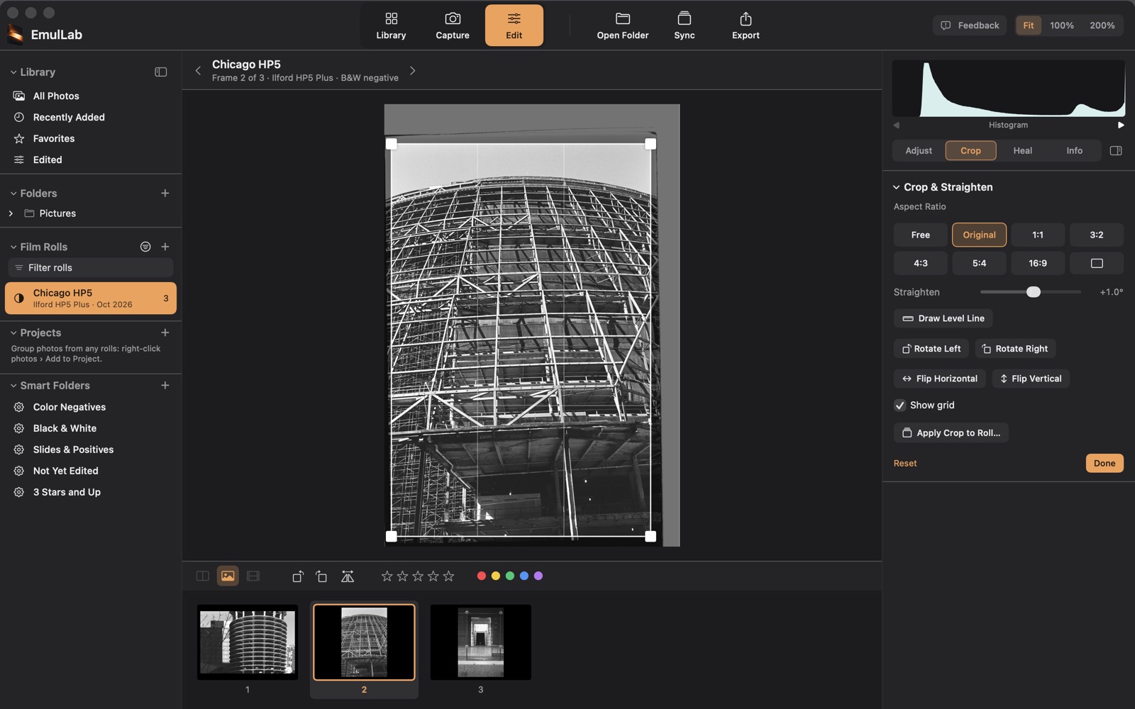 The Crop tab: a crop box with a grid over a black and white photograph of a steel frame, with aspect ratio, straighten, rotate and flip controls
